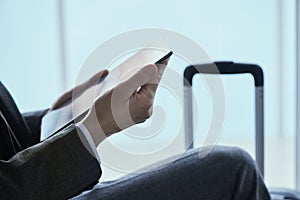 Businessman using his tablet at the airport