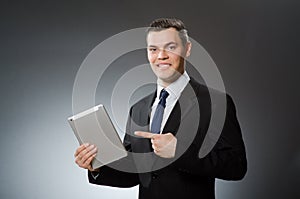 The businessman using his tablet computer in business concept