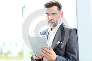 Businessman using his tablet in the office