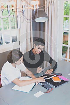 Businessman using ideas while working with tablets at office