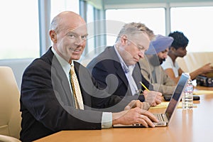 Businessman Using Laptop Besides Multiethnic Colleagues