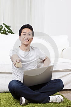 Businessman using a laptop on carpet