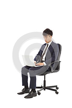 Businessman using laptop on the chair