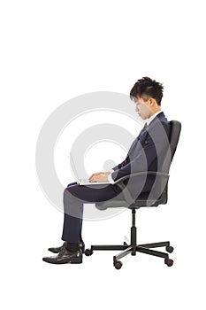 Businessman using laptop on the chair