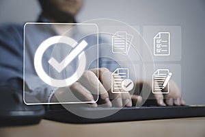 Businessman using laptop computer with correct sign and document icon for approve ISO which related quality control and continuous