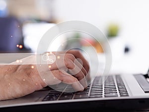 Businessman using laptop computer searching browsing Internet data information and working on wooden table.