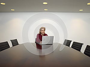 Businessman Using Laptop In Conference Room