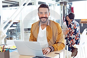 Businessman using laptop on desk in the office