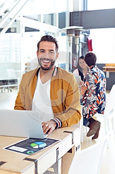 Businessman using laptop on desk in the office