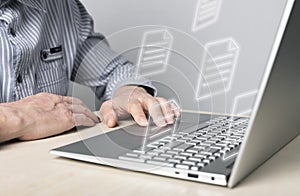 Businessman using laptop for electronic documents, letters sending and receiving. Man sitting at desk with computer