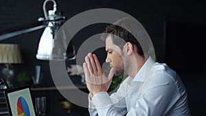 Businessman using laptop for job in office. Man analyzing graphics on laptop