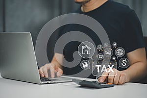 Businessman using laptop for online income tax return form. Symbolic of financial research, government taxes, and tax