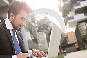 Businessman using a laptop outdoor