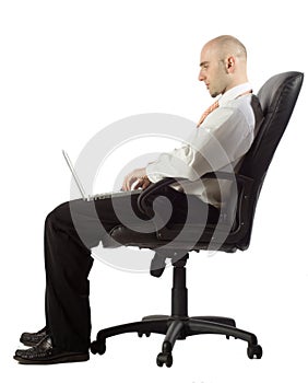 Businessman using laptop while seated