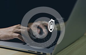 Businessman using laptop showing shield icon with lock sign. Computer password protection concept, internet network security,