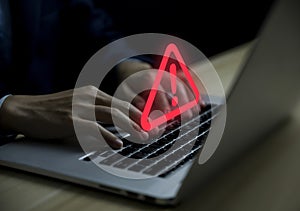 Businessman using laptop showing warning triangle and exclamation sign icon Warning of dangerous problems Server error. Virus.