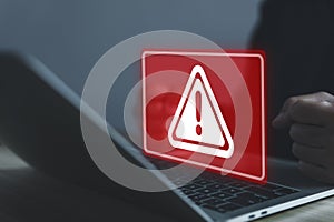 Businessman using laptop showing warning triangle and exclamation sign icon Warning of dangerous problems Server error. Virus.