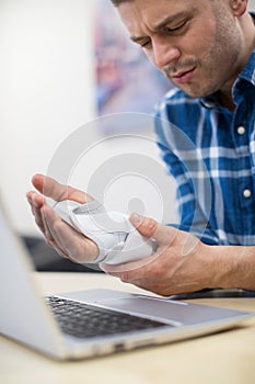 Businessman Using Laptop Suffering From Repetitive Strain Injury photo