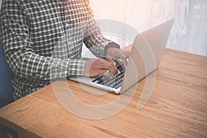 Businessman using laptop on wood table
