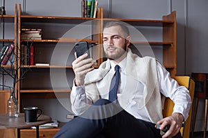 Businessman using mobile phone app texting indoor