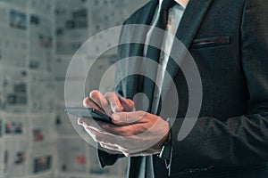 Businessman using mobile phone in fake news infodemic concept photo