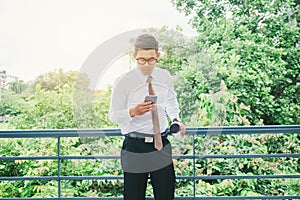 Businessman Using Mobile Phone Hand holding Coffee cup outdoor