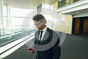 Businessman using mobile phone in a modern office building