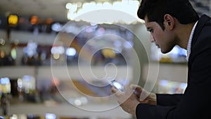 Businessman using a mobile phone in shopping mall