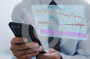 Businessman using mobile phone to analyze stock market and economic growth chart with icons on a virtual screen. business strategy