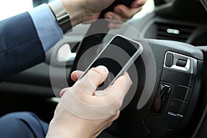 businessman using mobile smart phone while driving the car