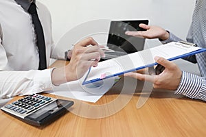 Businessman is using a pen for financial data analyzing counting