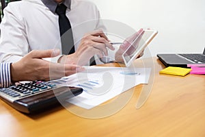 Businessman is using a pen for financial data analyzing counting