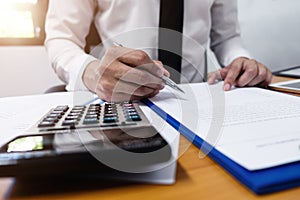 Businessman is using a pen for financial data analyzing counting