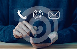 businessman using a phone to contact customer support shows a contact icon