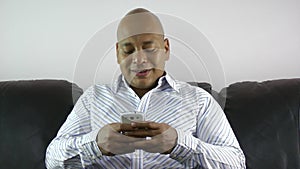 Businessman using smart phone emailing at home