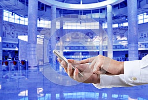 Businessman using smart phone in front of the subway station background