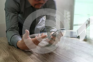 businessman using smart phone and keyboard dock digital tablet.Worldwide network connection technology interface.on wooden
