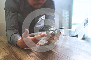 businessman using smart phone and keyboard dock digital tablet.Worldwide network connection technology interface.on wooden