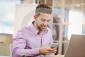 Businessman using smart phone in office