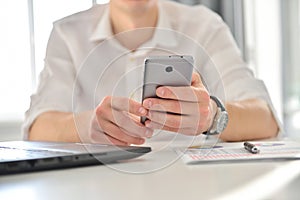 Businessman using smart phone in workplace