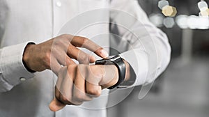 Businessman using smart watch in office, Closeup of young man hand touching device screen