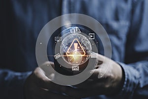 Businessman using smartphone with caution warning sign for notification error and maintenance concept