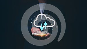 Businessman using a smartphone for cloud computing data transfer with uploading icons, Concept of digital storage, networking