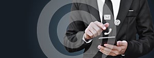 Businessman using smartphone with contact us icon