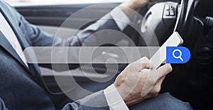 Businessman Using Smartphone While Driving Car With Empty Search Bar On Foreground