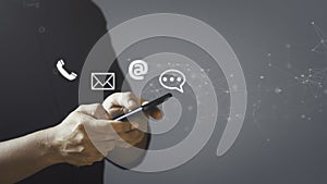 Businessman using smartphone with the email, call phone, address, Chat message icons.