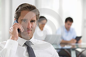 Businessman using a smartphone during a meeting