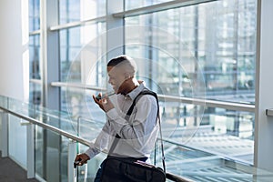 Businessman using smartphone in modern building
