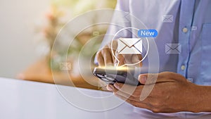 Businessman using smartphone with new email alert. Communication connection messages in global workplaces through email marketing