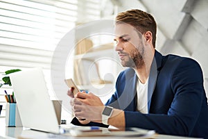 Businessman using smartphone in office